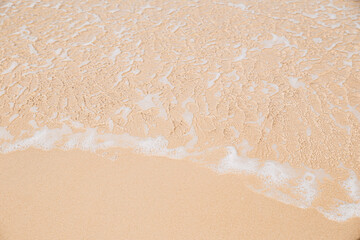 Sea wave coming on sandy beach view from top