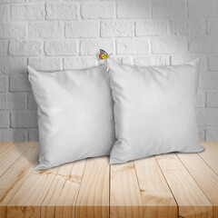 Mockup Blank white square pillow cotton with butterfly. On a wooden table and on a white wall