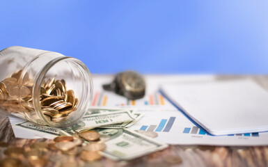 coins are sprinkled on a wooden table.