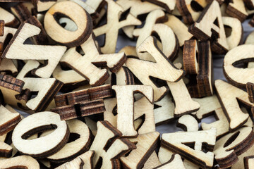messy alphabet letters made of wood.