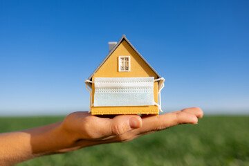 House wearing protective mask in hand