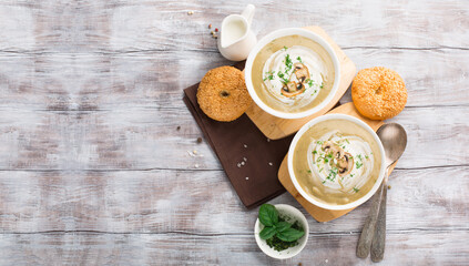 Mushroom cream soup on white wooden background.