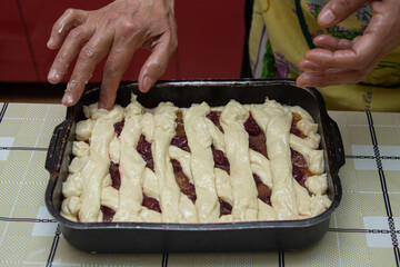 Making homemade pie. Female hands are working with dough. Home cooking. Homemade baking.