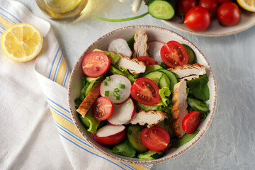 Grilled chicken breast, fillet and fresh vegetable salad of lettuce, spinach, cucumber and tomato