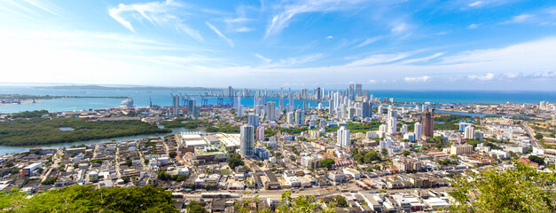 Flag wavering in front of scenic view of Cartagena modern skyline near historic city center and...