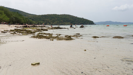 Fototapeta na wymiar People sunbathe and swim.People walk on the beach after low tide