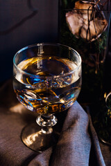 modern beautiful dark interior, room gray color, wardrobe shelves unusual gloomy decor table fabric cloth, dried flowers, vases with water, moss, branches, unusual style, halloween