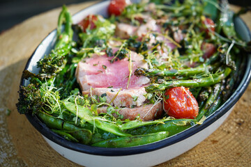 Grilled Tuna steak with roasted asparagus, tomatoes, pea pods and broccoli