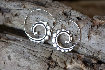 Silver metal decorative oriental spirale design earrings on natural neutral background - 433245005