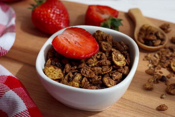 A bowl of granola with strawberries close-up. Delicious breakfast, morning concept. Healthy food