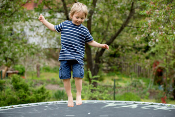 Child, jumping high on a trampoline
