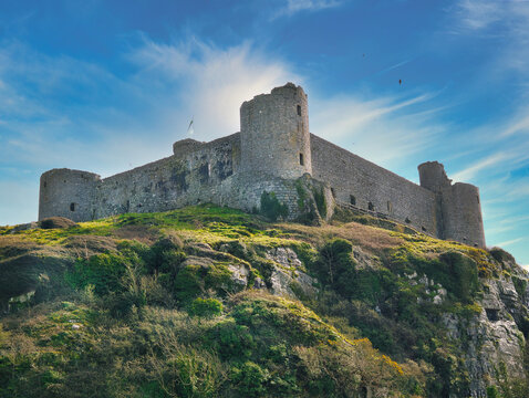 Beautiful landscape with the Castle of Harlech against a blue sky background