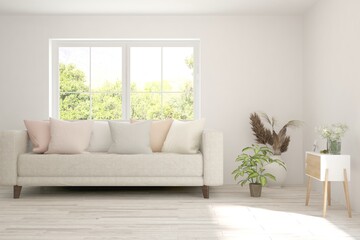 Fototapeta premium White living room with sofa and summer landscape in window. Scandinavian interior design. 3D illustration