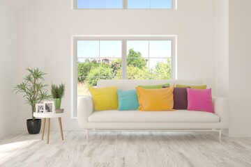 White living room with sofa and summer landscape in window. Scandinavian interior design. 3D illustration