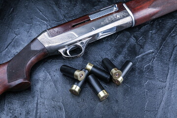 retro hunting rifle and bullets on black background, top view.