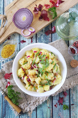 German cuisine. Potato salad with red and green onions, mustard and olive oil sauce