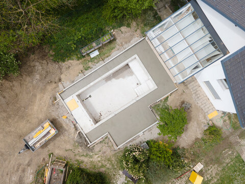 aerial drone flight pic of Swimming pool construction site from above in a garden in austria