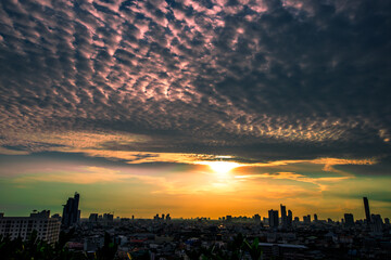 The blurred abstract background of the morning sun exposure to the tiny dust particles that surround the tall buildings in the capital, the long-term health issue of pollution.
