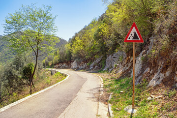 Balkan road trip. Old country road with a sign of falling stones. Montenegro, Tivat
