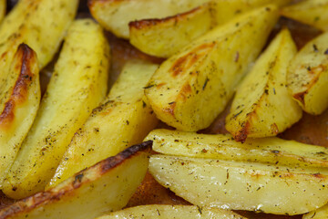Fried potato wedges. Homemade fried food. Fried vegetables. Tasty food.