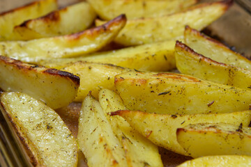 Fried potato wedges. Homemade fried food. Fried vegetables. Tasty food.