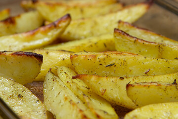 Fried potato wedges. Homemade fried food. Fried vegetables. Tasty food.