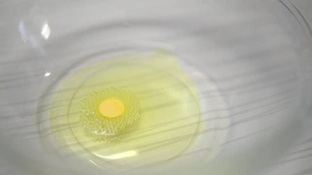 The yellow tablet dissolves in a plate of liquid. Easter egg paint