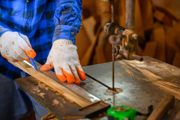 Carpenter or craftsman Use a circular saw to saw the wood. In workshop Carpentry office background
