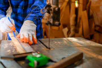 Carpenter or craftsman Use a circular saw to saw the wood. In workshop Carpentry office background