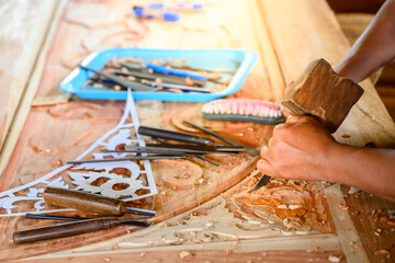 Asian male craftsmen carved wood craftsmen use wooden hammers to shovel wood chisels tools...
