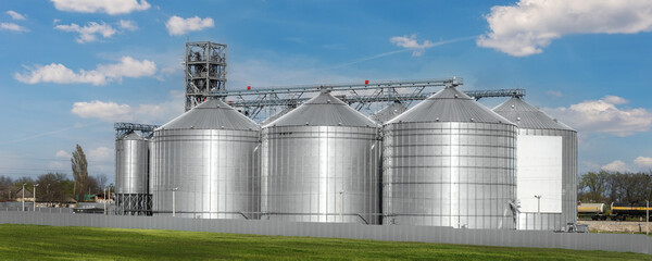 Scenic view of big modern steel agricultural grain granary silos cereal bin storage warehouse...