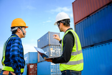 Engineer talking to a young Asian foreman work in freight industry transport and logistics concept	