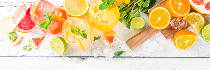 Summer cold drinks, fruit lemonade sangria cocktail, infused beverages with various citrus - orange, lemon, grapefruit, lime, with fresh fruits copy space - obrazy, fototapety, plakaty