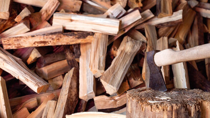 Ax on the background of firewood in the village, copy space for text. Hardwood