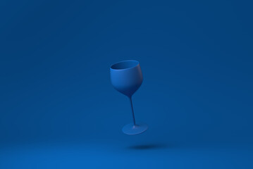 Blue Wine glass floating in blue background. minimal concept idea creative. monochrome. 3D render.
