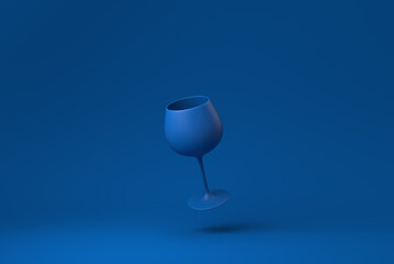 Blue Wine glass floating in blue background. minimal concept idea creative. monochrome. 3D render.