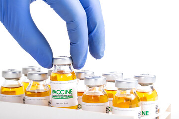 Doctor in medical glove holds in his hand a vial of vaccine for injection for coronavirus COVID-19...