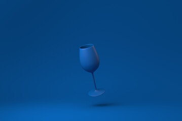Blue Wine glass floating in blue background. minimal concept idea creative. monochrome. 3D render.