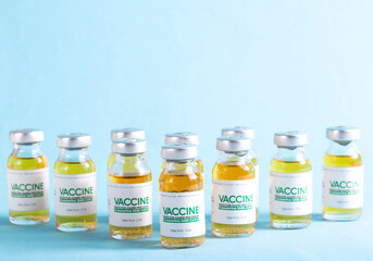 Vials with a new modern medicine for coronavirus on a blue background in the laboratory. Copy space for text, SARS-Cov-2