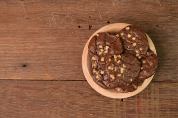 Chocolate brownie cookies on wooden plate. Malaysian traditional cookies served during Eid Fitri.