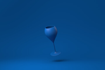 Blue Wine glass floating in blue background. minimal concept idea creative. monochrome. 3D render.