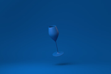 Blue Wine glass floating in blue background. minimal concept idea creative. monochrome. 3D render.