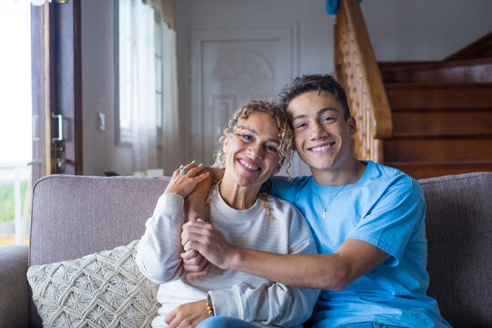 Portrait of grateful teenager man hug smiling middle-aged mother show love and care, thankful happy grown-up son in embrace cheerful mom, enjoy weekend family time at home together, bonding concept
