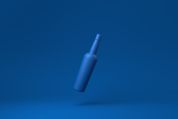 Blue brandy bottle floating in blue background. minimal concept idea creative. monochrome. 3D render.