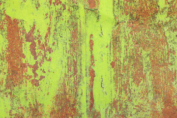 texture of green rusty metal with scratches. Grunge panorama. Multicolored background: rusty metal surface with peeling and cracking green paint. Close-up of rusty metal texture.  