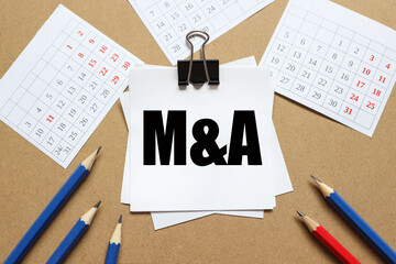 Mergers and Acquisitions. M and A. the text on the sticker near the calendar and karagdash. the...