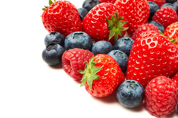 Strawberries, raspberries and blueberries on a white background.
