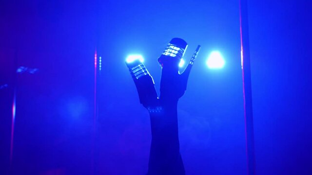 Slender legs of pole dancer in stripper shoes in the club. Pole dance.