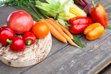 Summer harvest on a wooden table. Assortment of vegetables carrots and tomatoes, bell peppers and beets. Copy space for text, farming