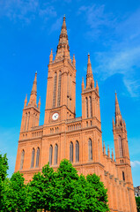 Fototapeta na wymiar Catholic brick cathedral with clock, Europe landmark